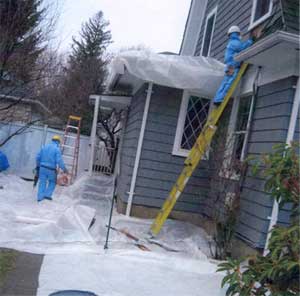 Hazmat suits protect lead abatement specialists during demolition