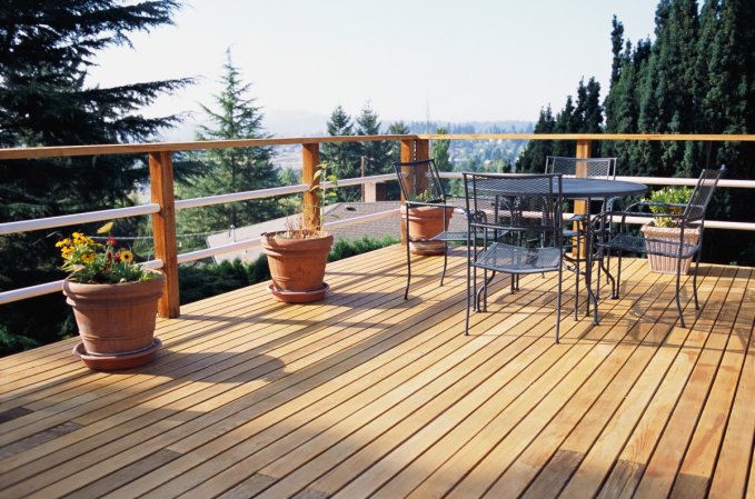 An outdoor wood deck looking out across the treetops