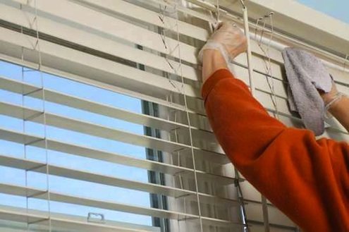cleaning window blinds with microfiber cloth