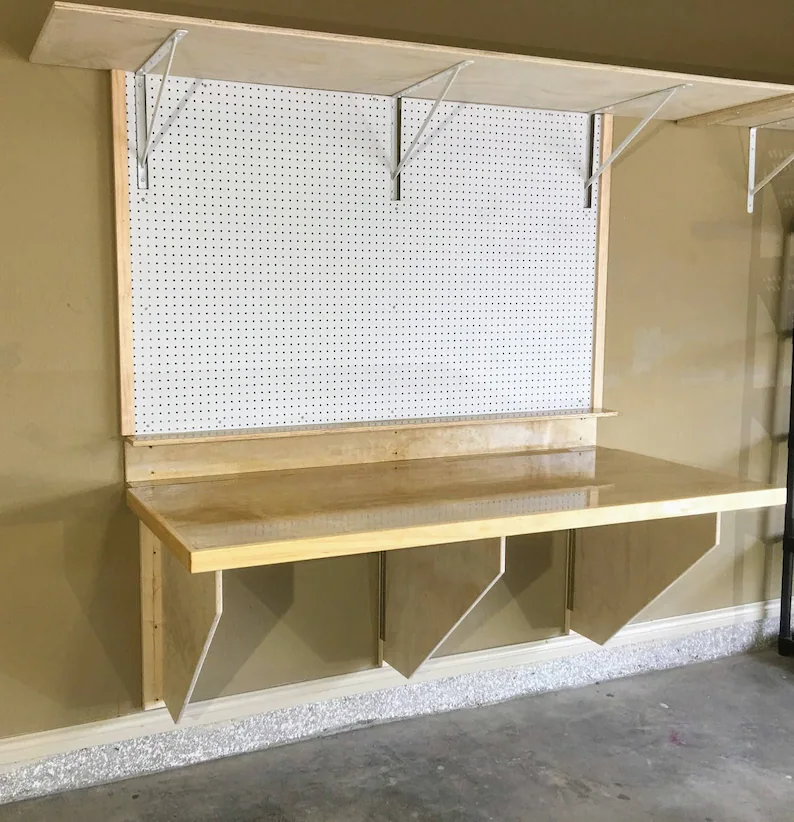 A wall-mounted worktable installed in a home garage.
