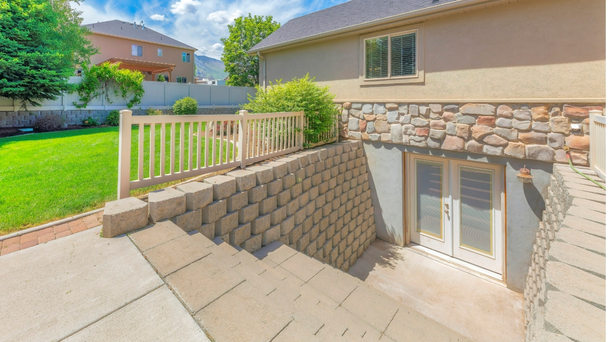 The exterior entrance to a basement leading out to a backyard