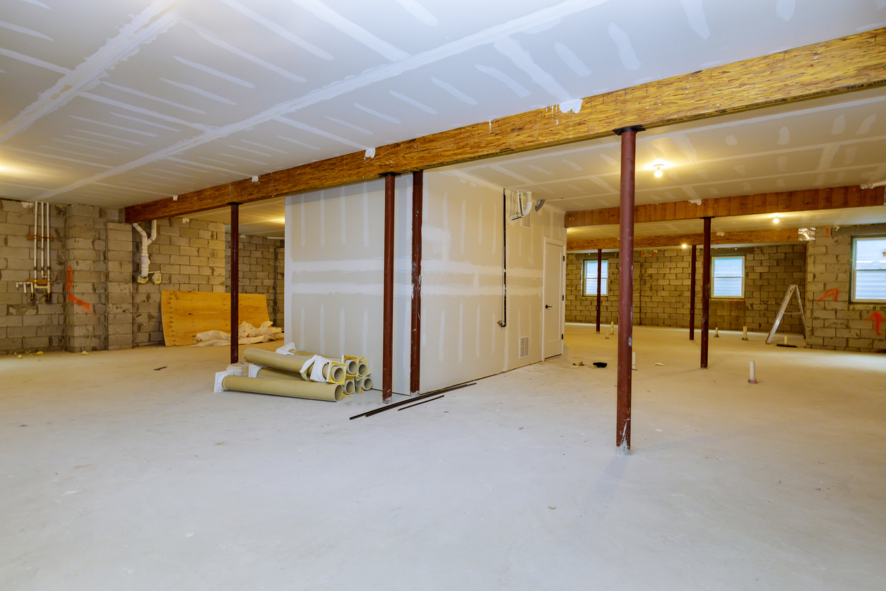 Support beams and columns in an unfinished basement.