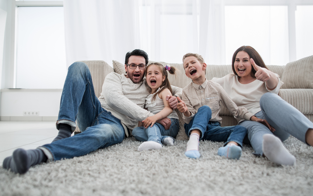 happy family sitting on the carpet in the living room.the concept of family happiness
