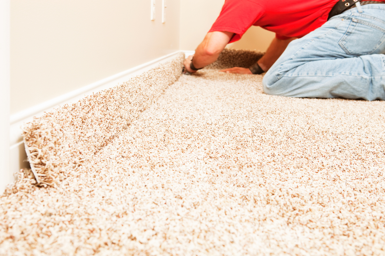 Bedroom Carpet Installation with Worker Cutting