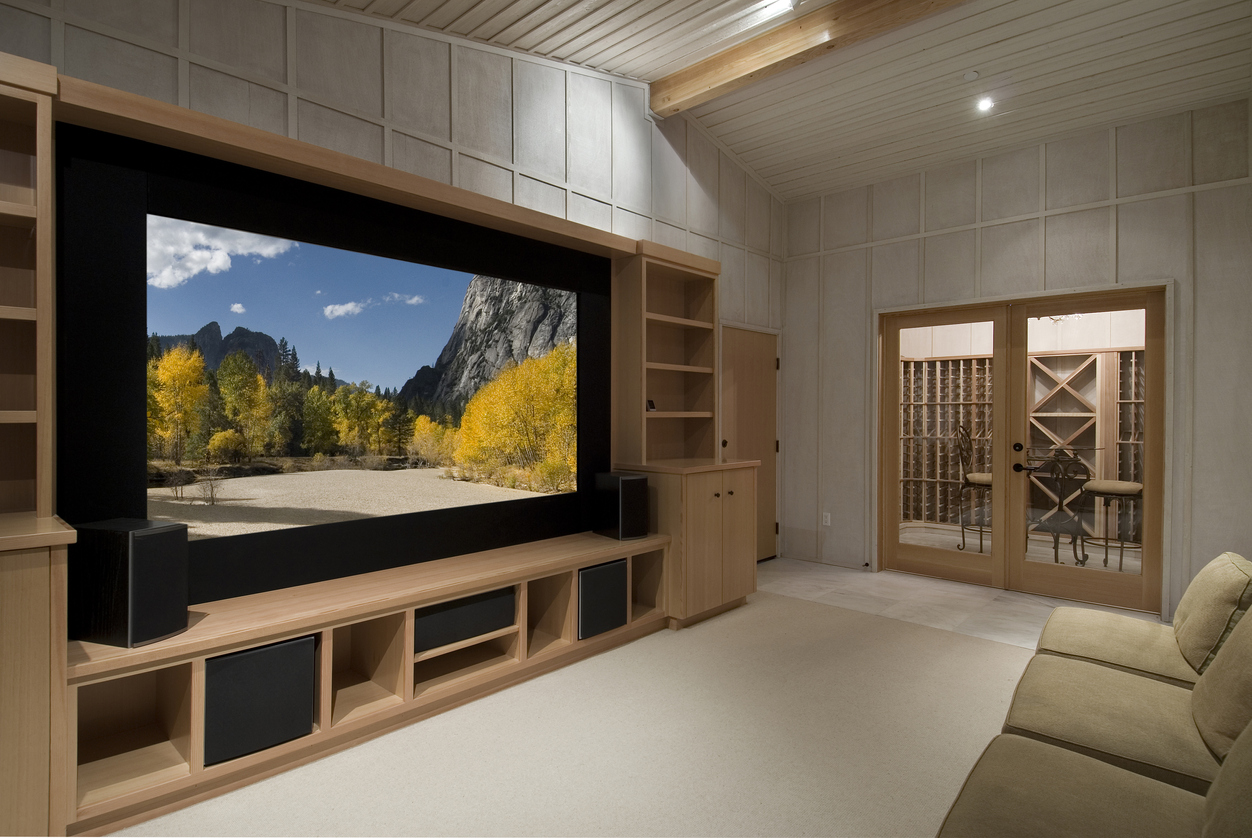 home theater with wine tasting room, big screen, wood cabinets,photo on screen is one of my shots from yosemite
