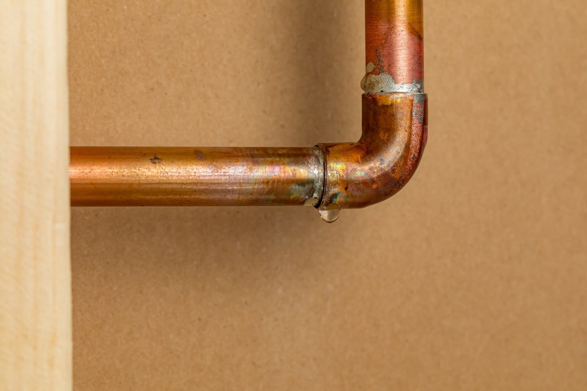 Exposed copper pipe indoors that is leaking.