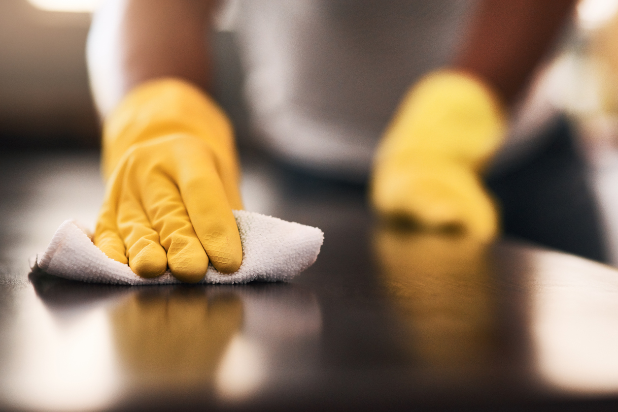 Cropped shot of an unrecognizable man cleaning a kitchen counter at home