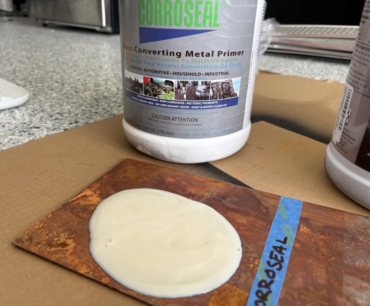 Corroseal rust converter bottle with sample poured on a rusty piece of metal.