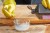 Person wearing rubber gloves pours hydrogen peroxide into a bowl with cream of tartar.