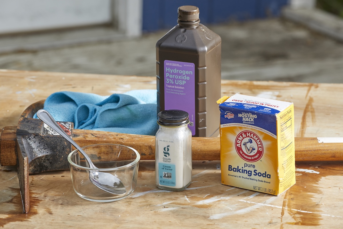 Materials needed for making rust remover: baking soda, cream of tartar, hydrogen peroxide, rusty axe.