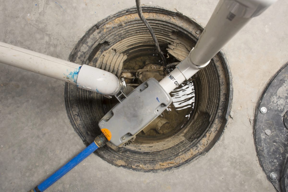 A newly installed sump pump in an uncovered sump pit as seen from above.