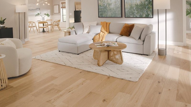 Light-colored beige decor and light floors in transitional living room with beige couch.