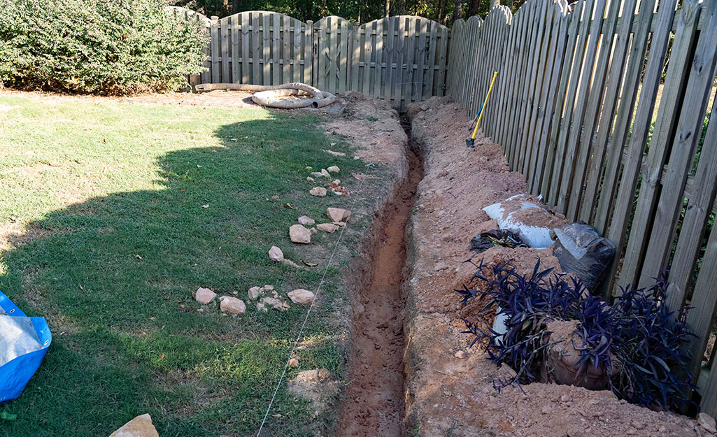 French Drain dug into back yard near fence