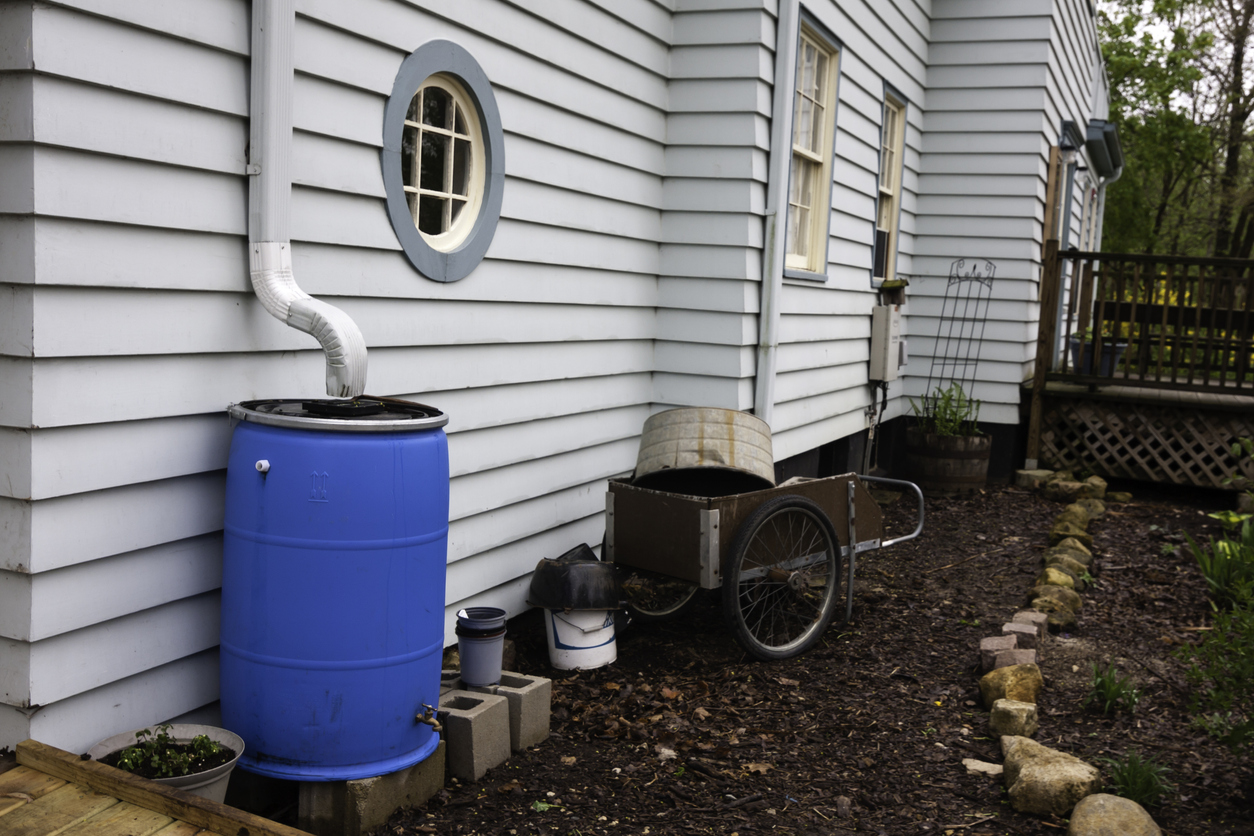 Blue Rain Barrel at side of house