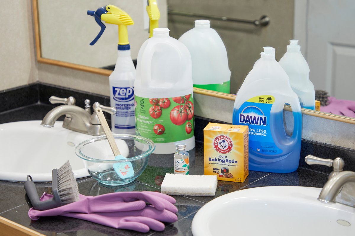 Static photo showing all of the ingredients used to make homemade shower cleaner.