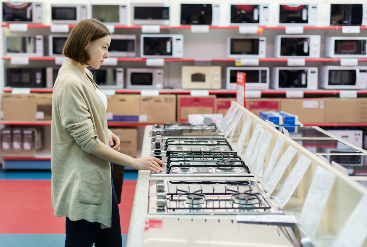 Woman shopping for gas ovens