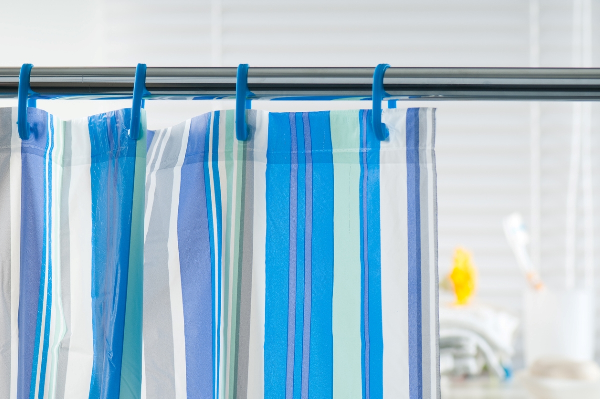 Close up of blue striped shower curtain.