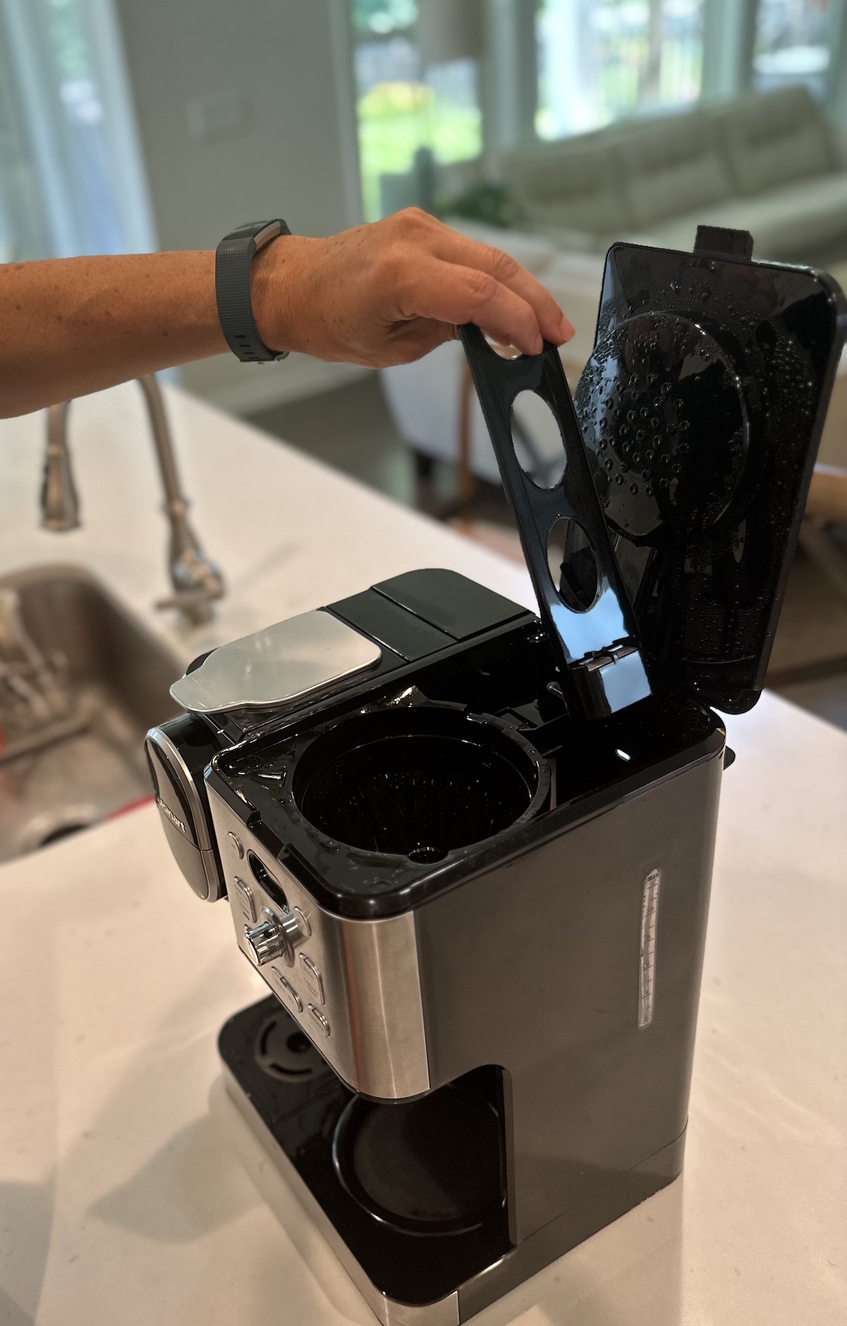 Man removing charcoal filter from Cuisinart coffee maker