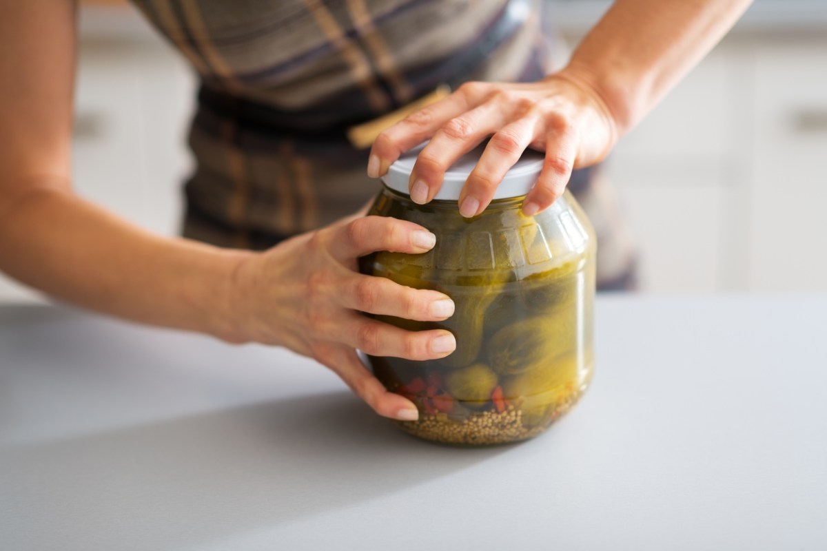 Home chef struggling to open a stuck jar