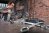 Man using wire tool to clean rust.