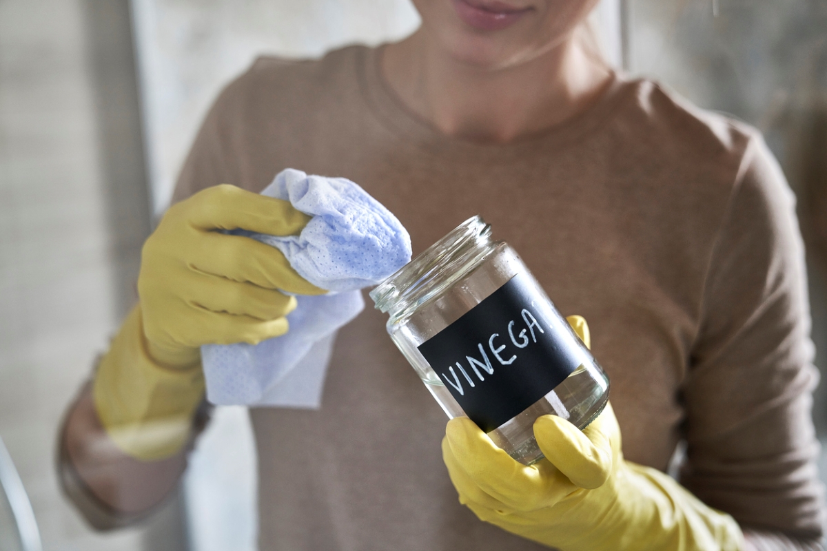 Person dipping microfiber towel in vinegar