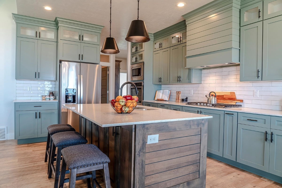 View of modern kitchen with seafoam colored cabinets