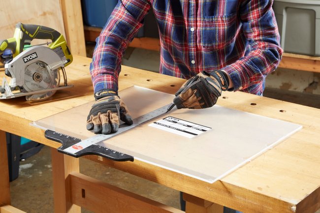 Person using metal ruler on thick plexiglass.