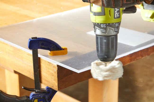 Using electric drill to buff plexiglass.