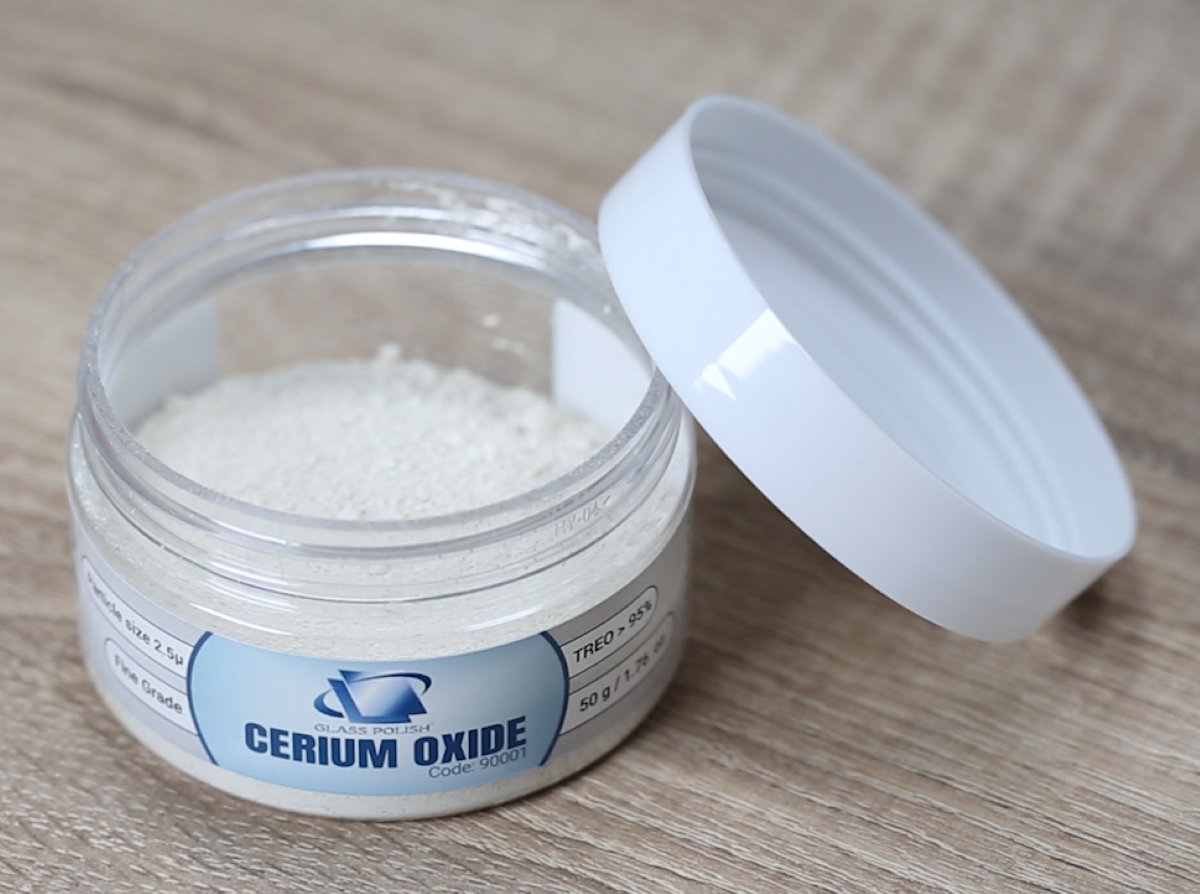 Opened cerium oxide jar with white powder.