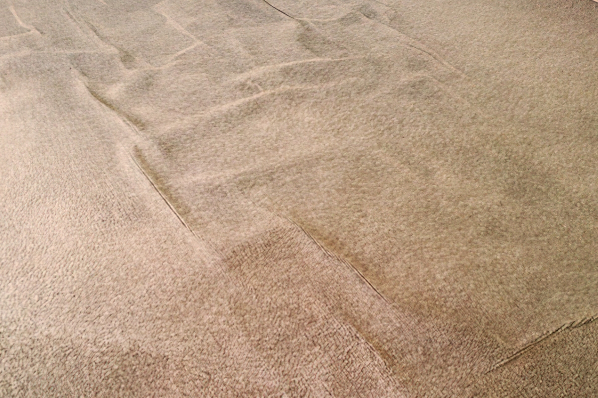 Buckled brown carpet.