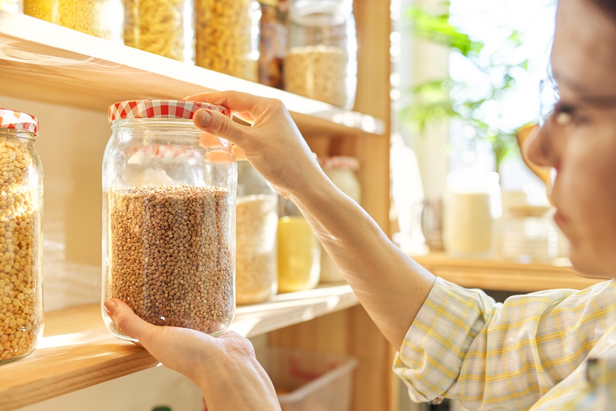 Woman inspecting dry goods in jar