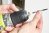 Woman inserts a screw extractor into a drill.