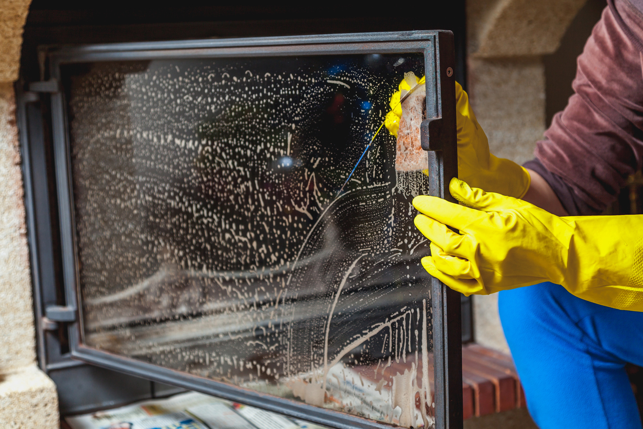 how to clean a fireplace cleaning glass doors with yellow gloves