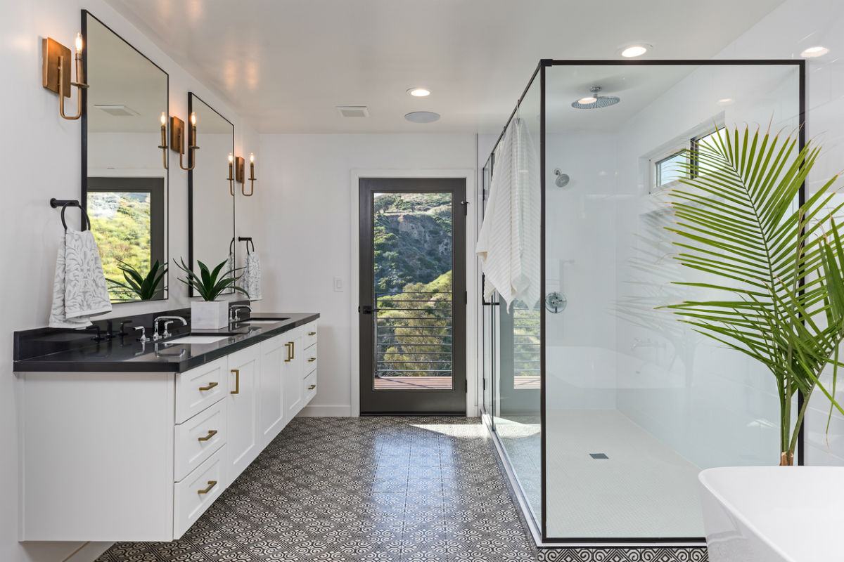 The best bathroom fan option shown in the ceiling of an large and inviting bathroom space