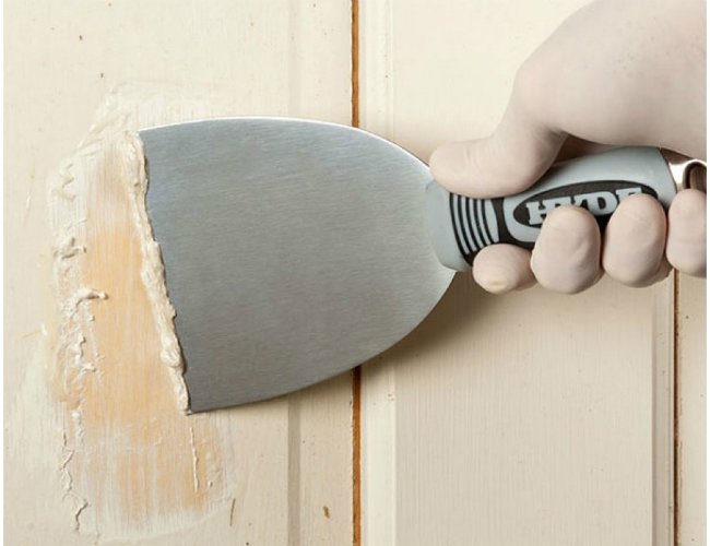 Hyde 4-inch Stiff Stainless Steel Scraper in action removing paint