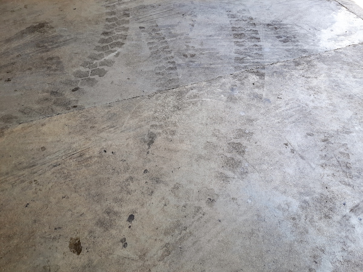Tire marks on concrete garage floor or driveway.