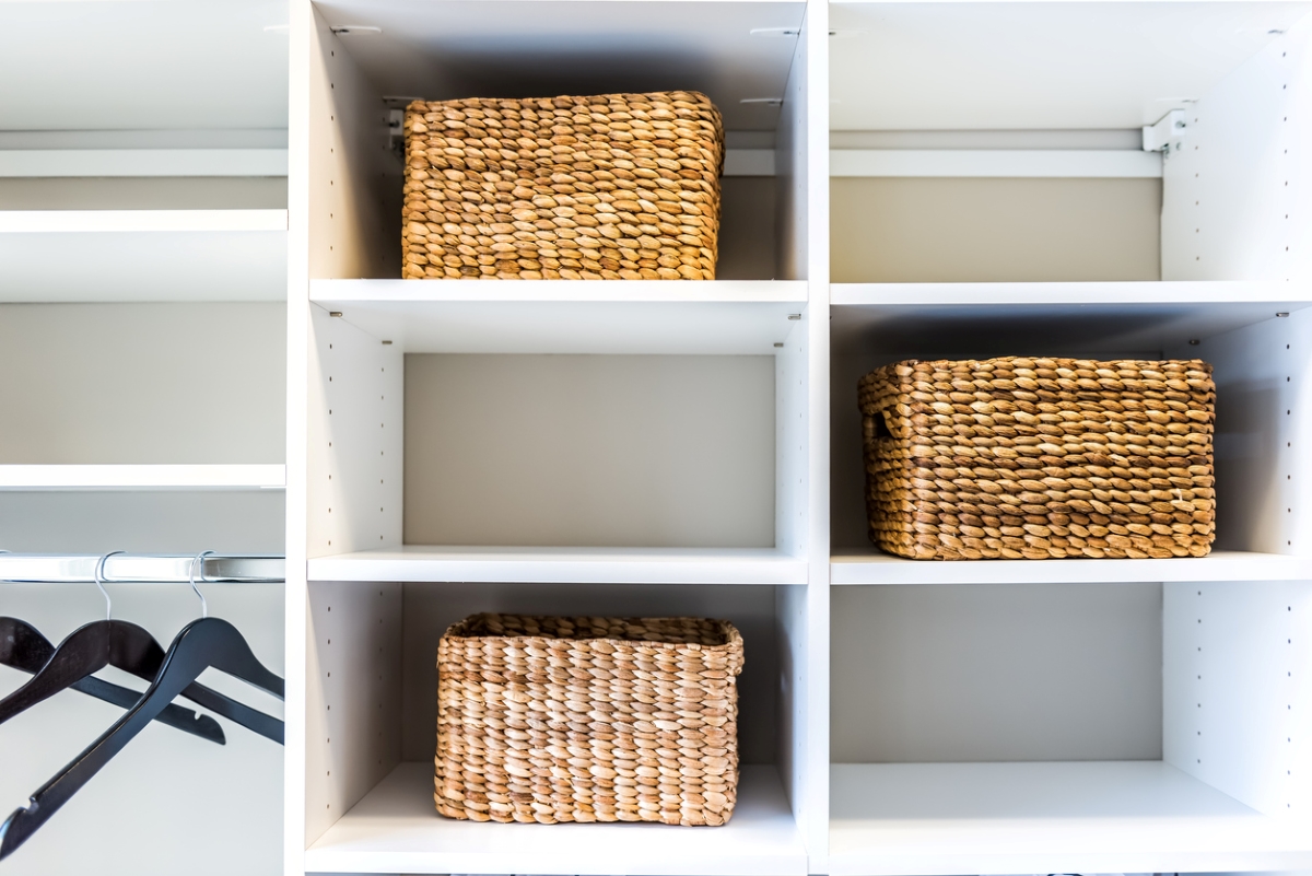 Seagrass baskets in white cubby shelves.