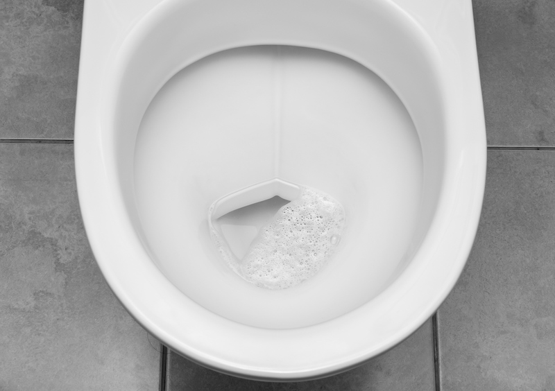 closeup of inside of toilet bowl with clear bubbling water