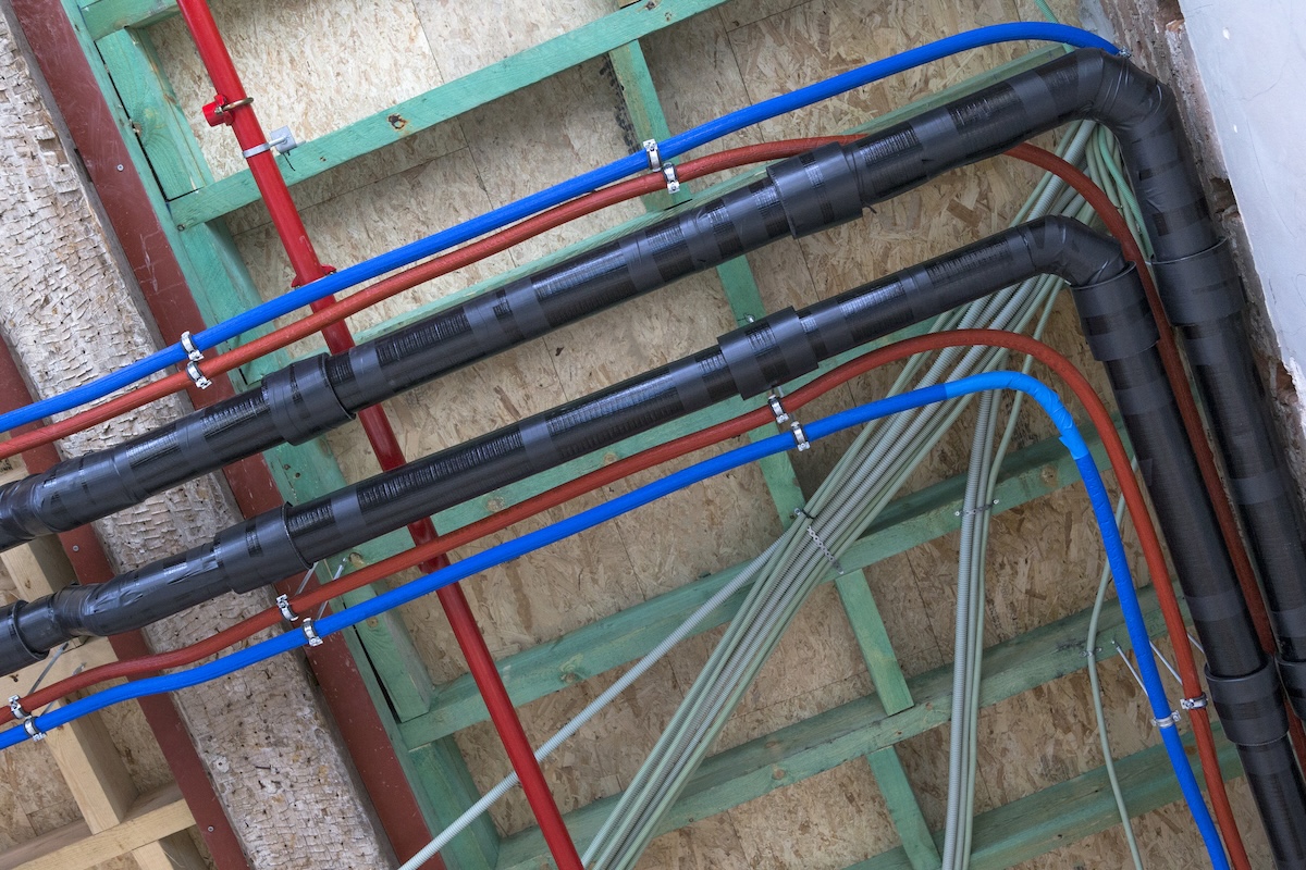 PEX A, PEX B, and PEX C pipes run alongside each other.