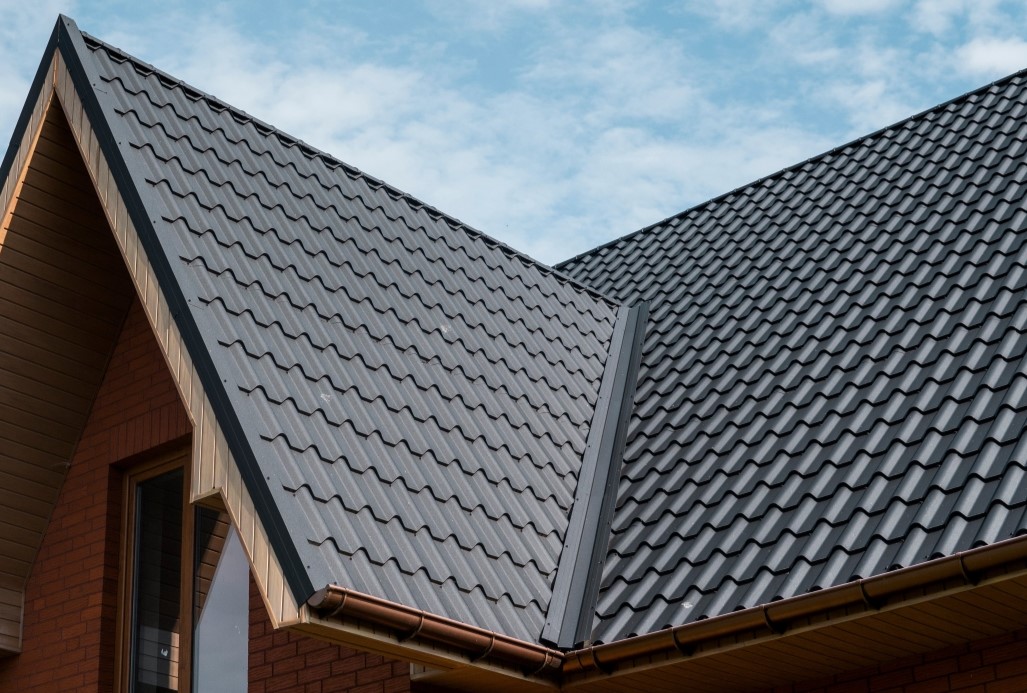 Modern roof covered with tile effect PVC coated brown metal roof sheets.