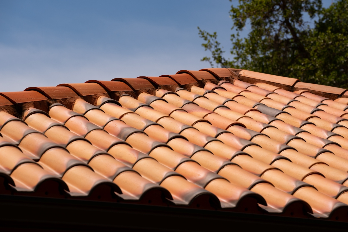 Close up of house rooftop covered with ceramic shingles.