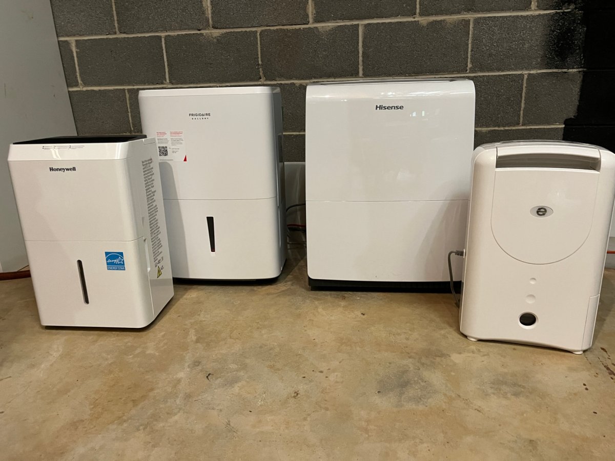 A group of the Best Dehumidifiers for Basements placed together in a basement