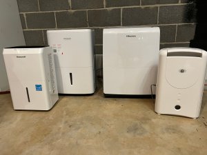 A group of the Best Dehumidifiers for Basements placed together in a basement