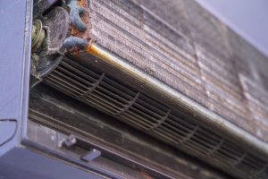 Old air conditioner and focus evaporator of dirty, foul, be putrid Before cleaning on the purple wall in the home office in the summer and circuit board control.