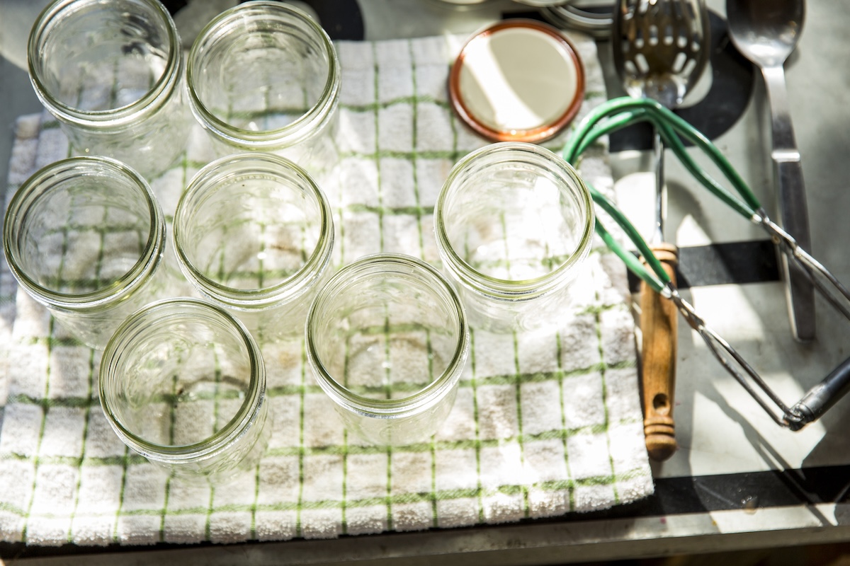 A set of glass jars prepared for sterilization.