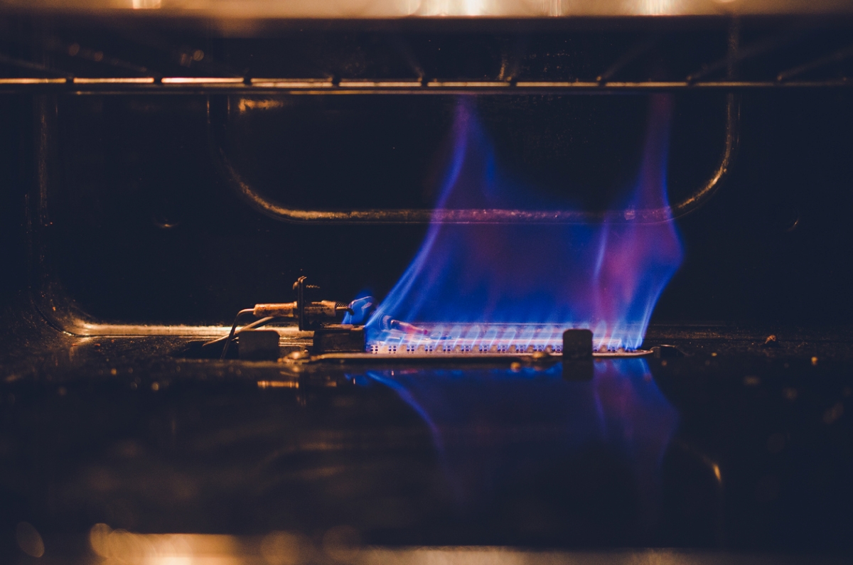Flame inside gas oven.