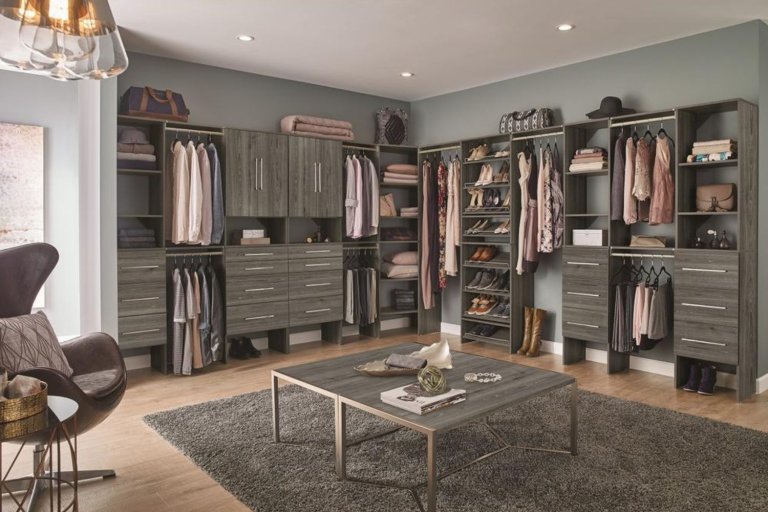 The Best Closet Systems installed in a large walk-in closet and filled with clothes