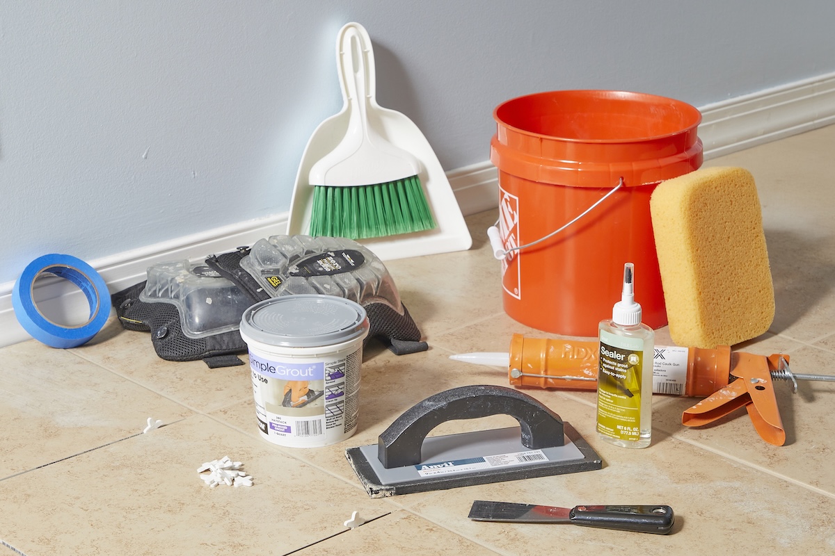 Materials needed for grouting tile, including bucket, sponge, grout, grout float, and more.