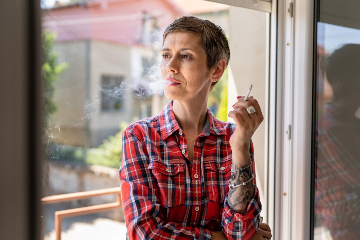 Woman smoking with window open