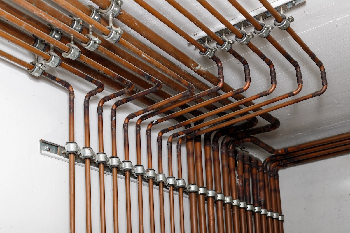 Copper water pipes system in the basement of residential house.